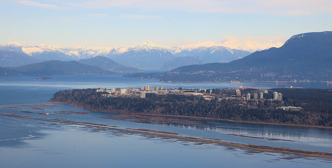 Aerial view of the University of British Columbia campus with mountains behind